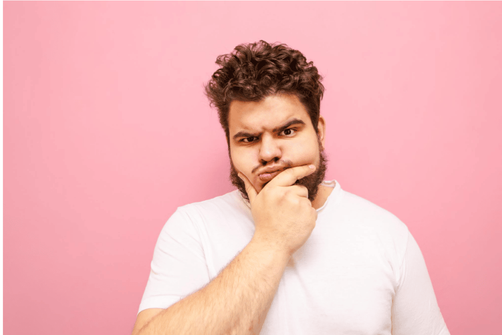 man pondering how to style a beard to make themselves look thinner