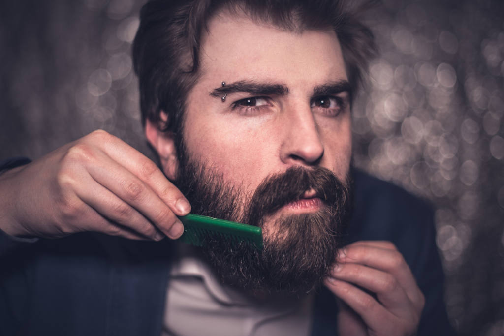 man combing his mustache to connect it to his beard