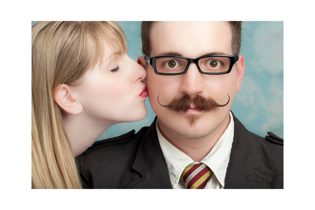 Woman kissing man with a mustache